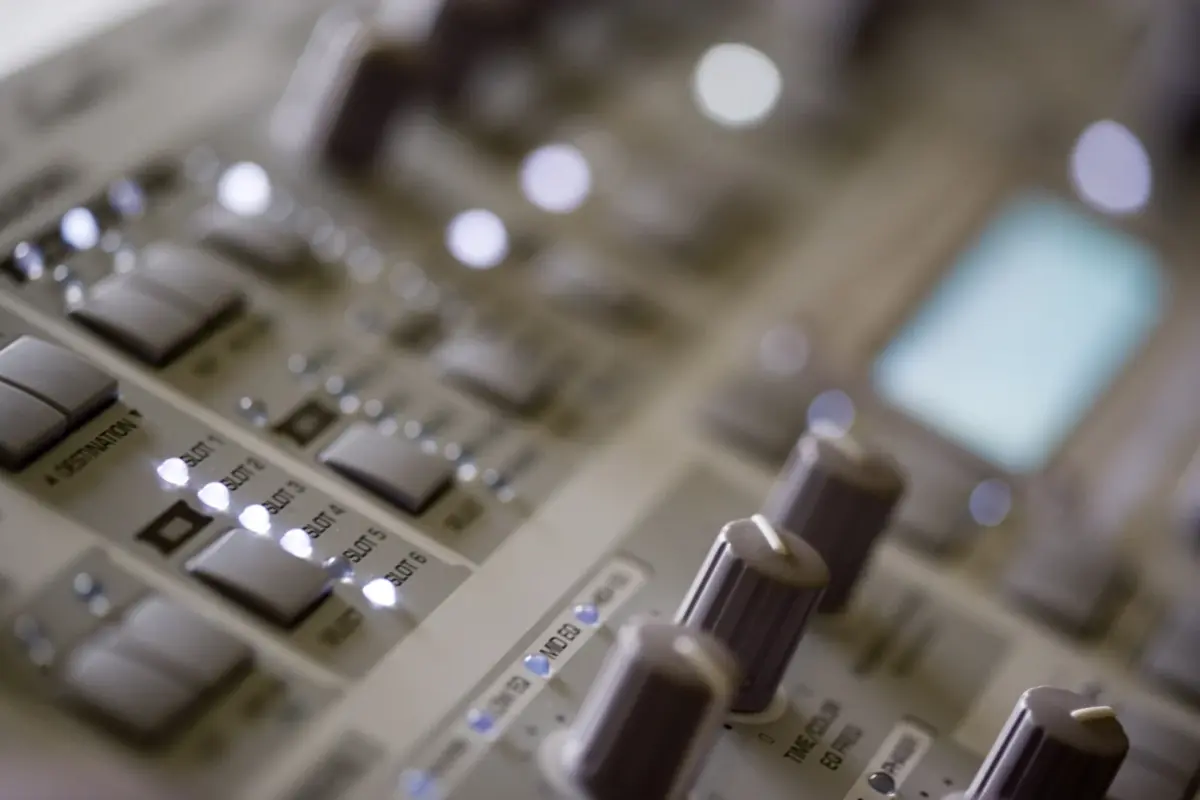 Close-up of Access Virus synth controls and display, advanced music production hardware with illuminated buttons and knobs